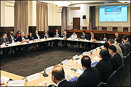 Secretary Pablos is seated along with other committee members at a a large desk. Name plaques are displayed in front of each individual.