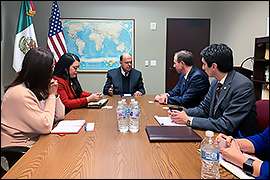 Secretary Whitley sitting in a conference room with Mexican Consul General, Carlos Cue Vega and staff