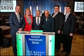 Secretary Pablos standing with individuals at the at the 2017 Global Petroleum Show in Calgary.