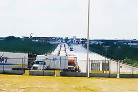 There is an extremely long line of trucks on the international bridge.

