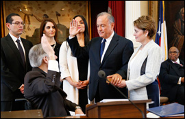 Secretary Cascos is sworn in as Texas Secretary of State by Governor Greg Abbot with family watching.