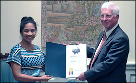 Secretary Nandita Berry presents Blue Bell CEO, President Paul Kruse, with a proclamation celebrating the company's 107 years.
