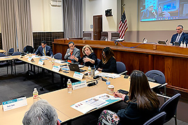 Secretary Nelson sitting at a table with other stakeholders.