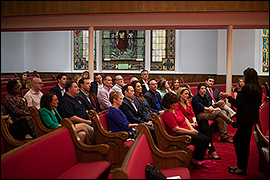 Secretary Whitley sitting in a church with other NASS members. 