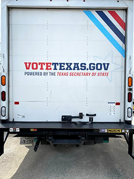 Back view of a truck that displays the VoteTexas.gov logo. 